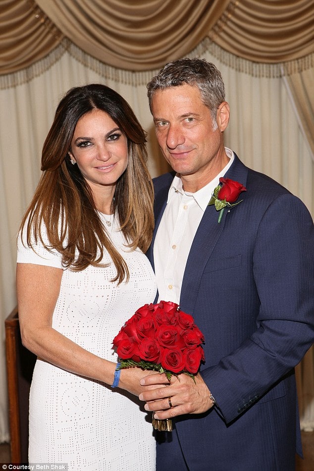 Beth Shak and Rick Leventhal carrying flower 